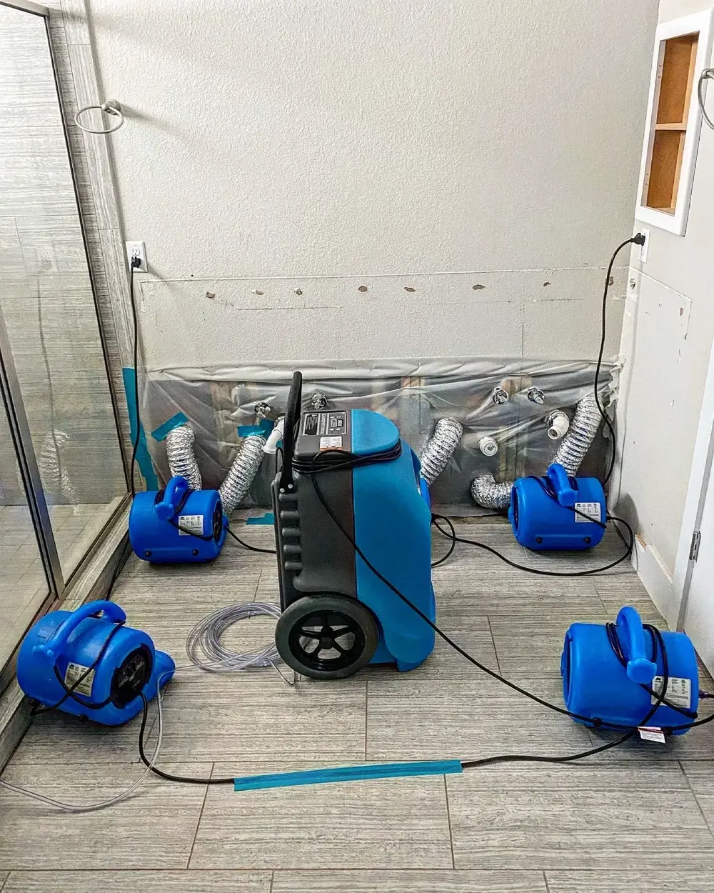 Wall cavity drying under plastic containment in a bathroom