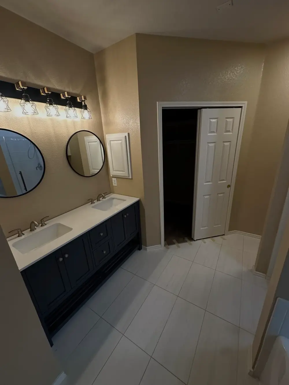 Finished bathroom with rebuilt double vanity and tile floor