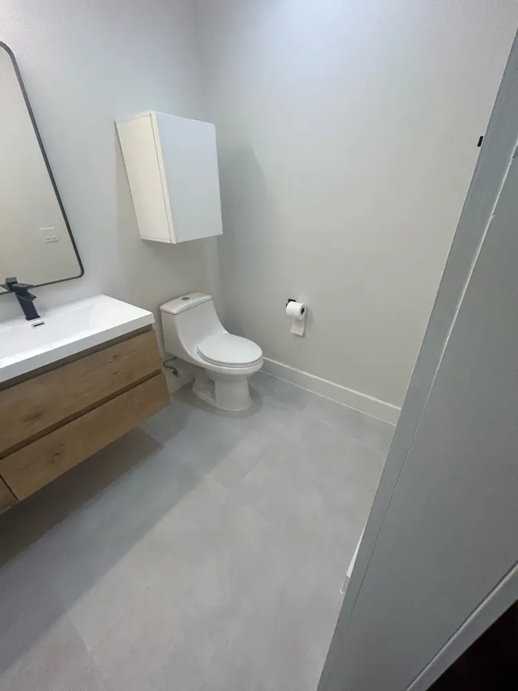 Finished modern bathroom with floating wood vanity