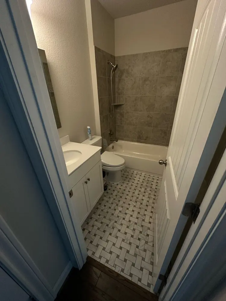 Finished bathroom with new tub surround and patterned floor