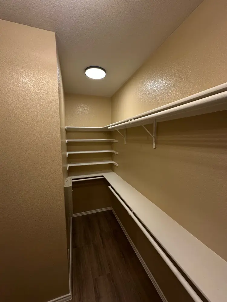 Finished walk-in closet with custom shelving