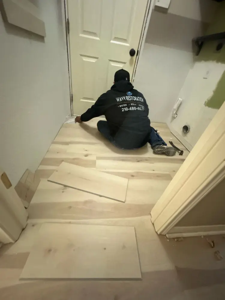 Wavy crew installing luxury vinyl plank flooring