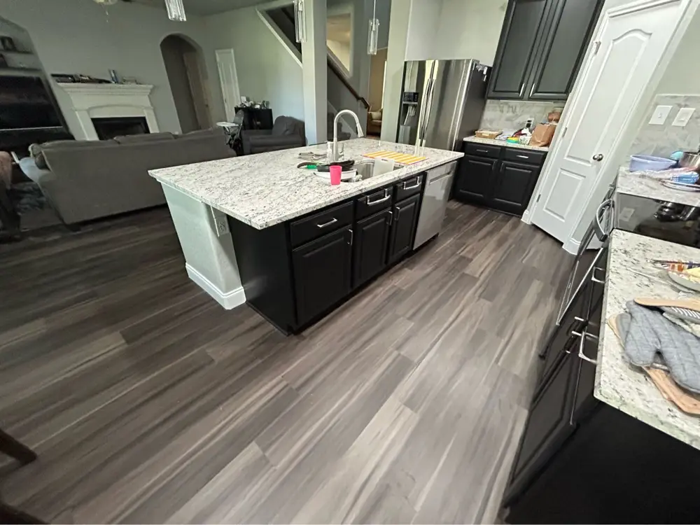 Finished kitchen with granite island and new flooring