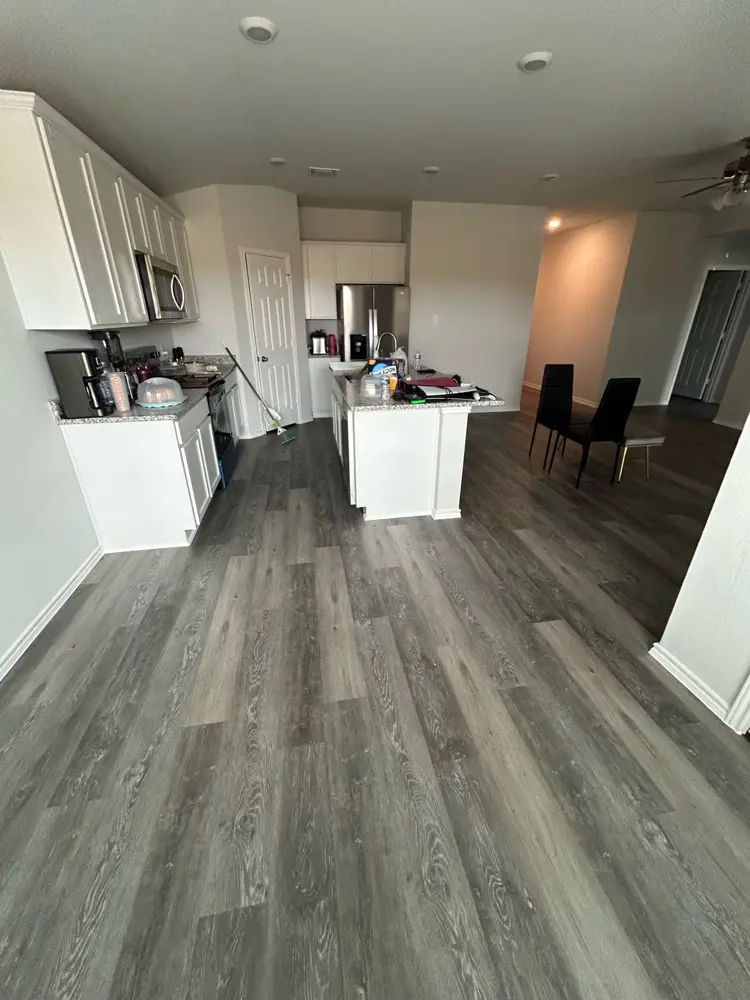 Finished kitchen with grey LVP flooring throughout
