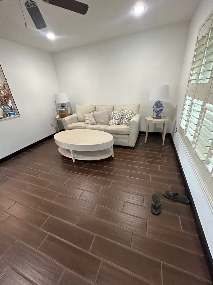 Finished living room with wood-look tile floor