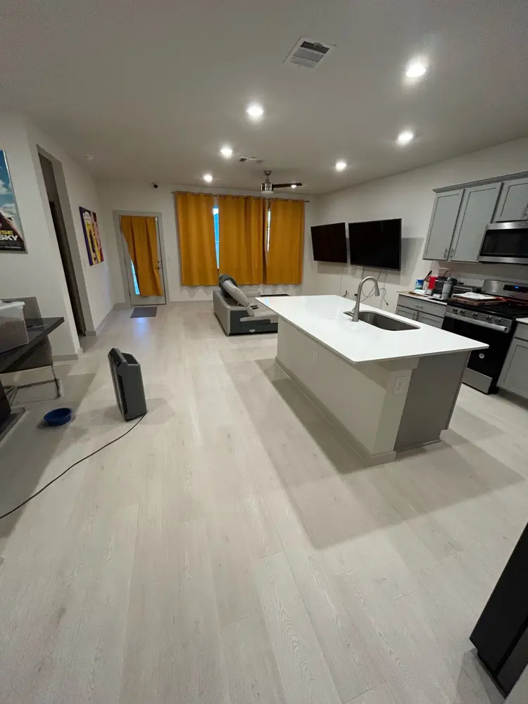 Finished open-plan living space with island kitchen