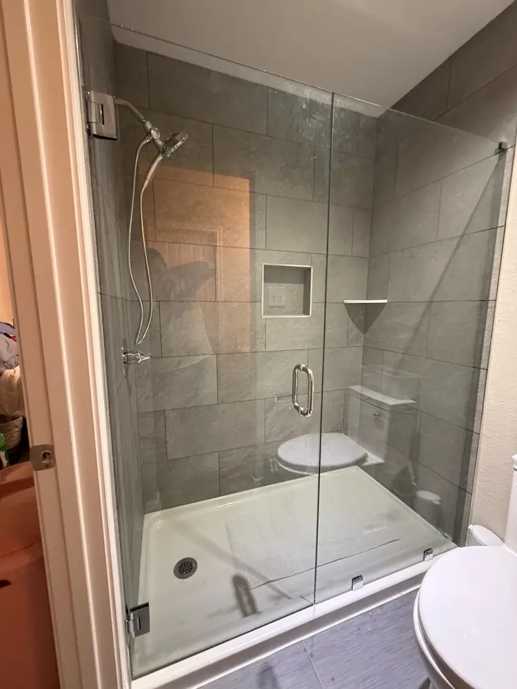 Finished walk-in shower in large-format grey tile