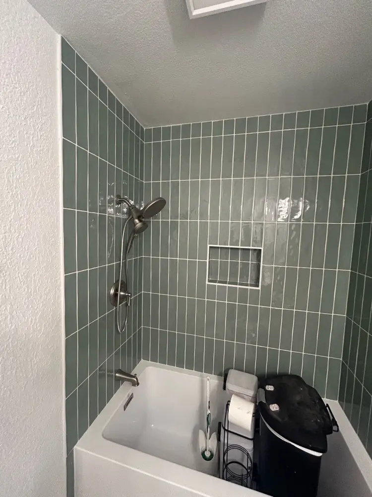 Finished tub with vertical green tile surround