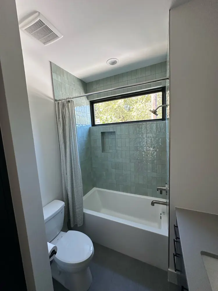 Finished tub surround in green tile