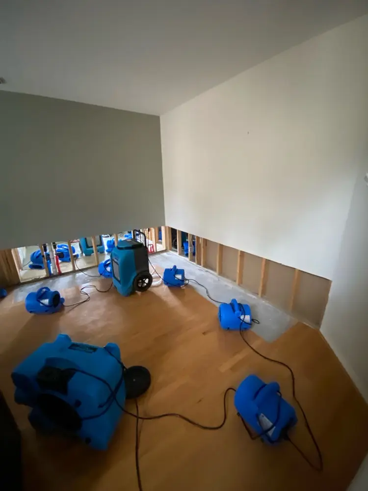 Air movers drying a dining room floor