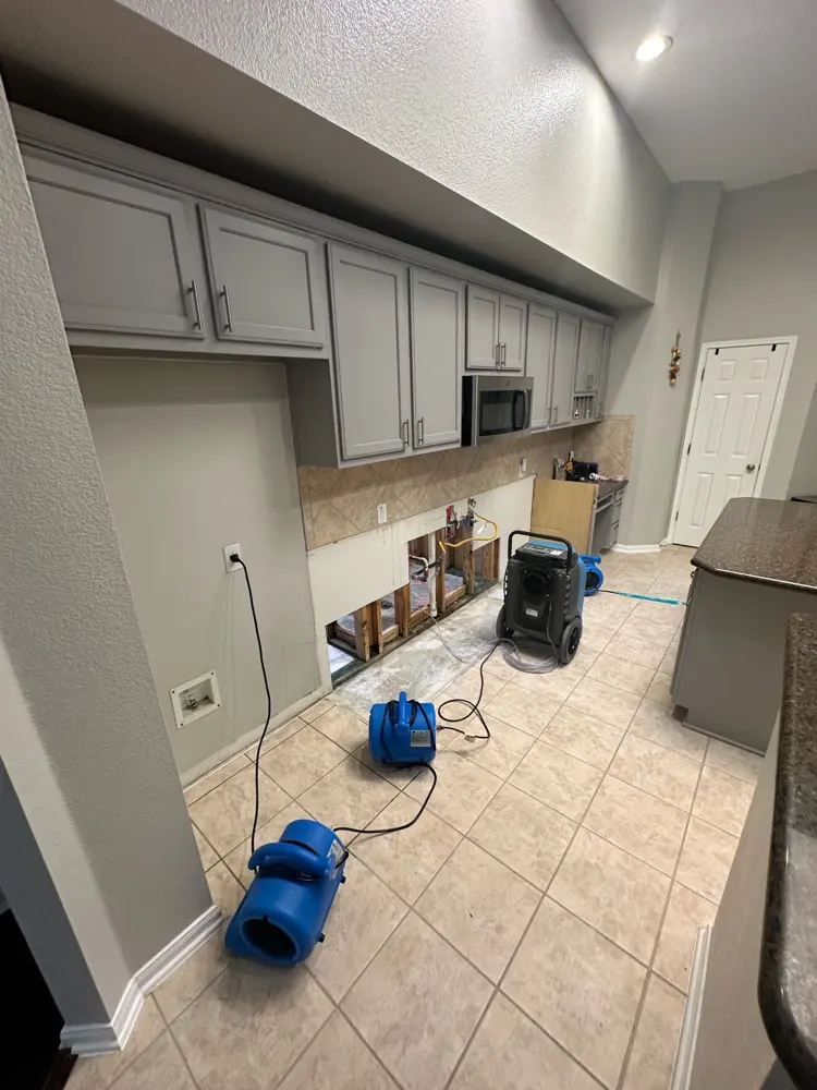 Air movers drying a kitchen after cabinet removal