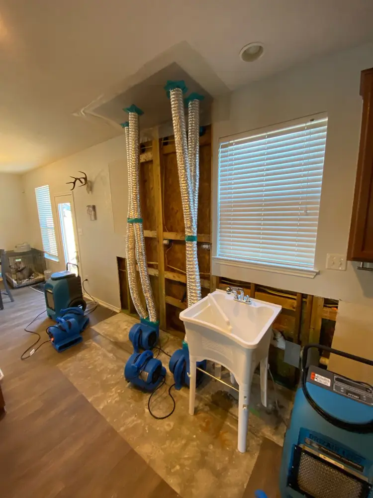 Laundry room wall opened and drying after a supply line leak