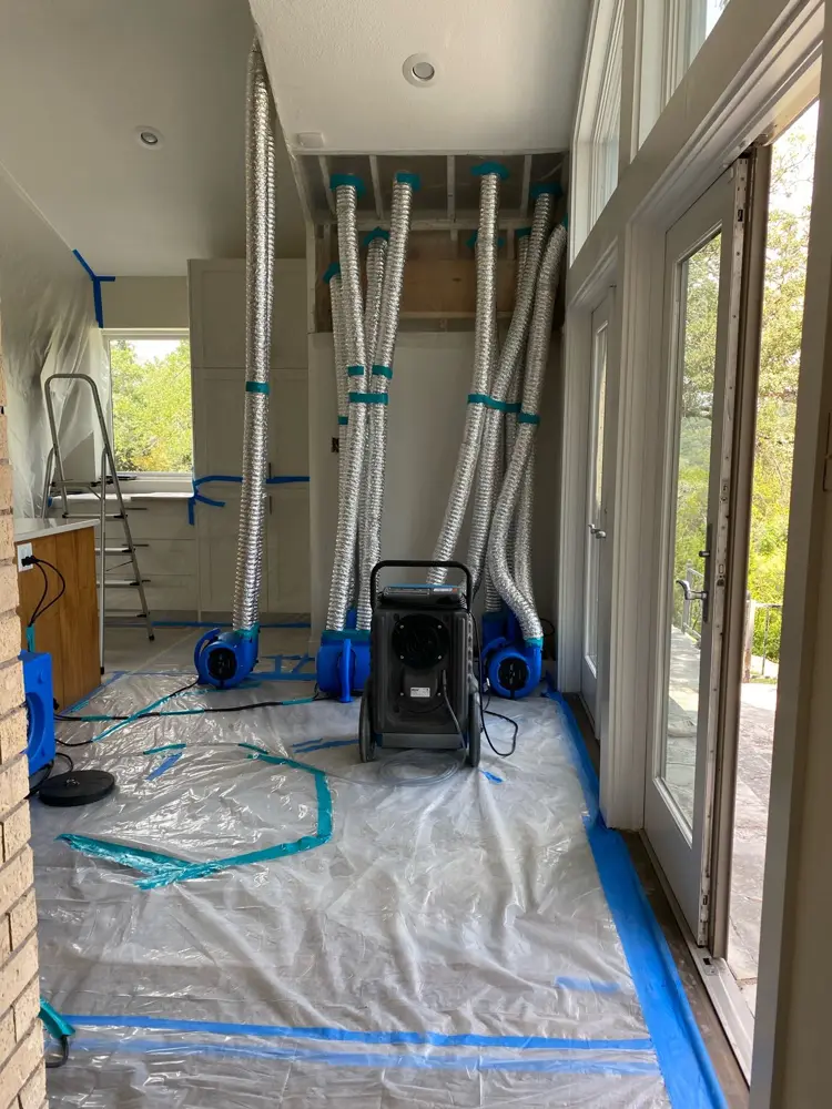 Room under plastic containment with drying equipment running